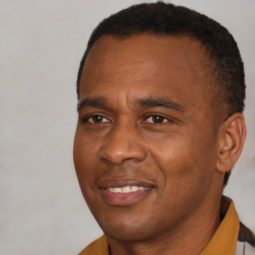 Joyful latino adult male with short  brown hair and brown eyes