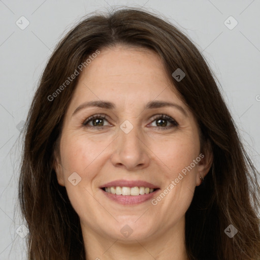 Joyful white adult female with long  brown hair and brown eyes