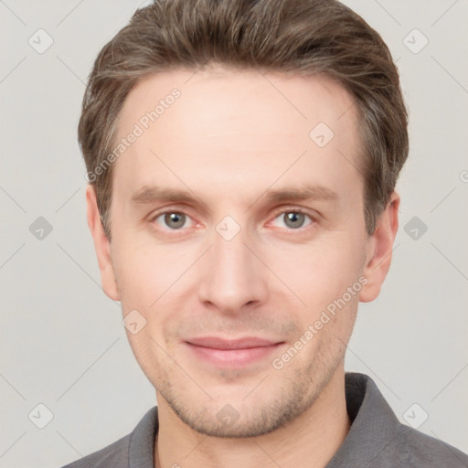 Joyful white young-adult male with short  brown hair and grey eyes