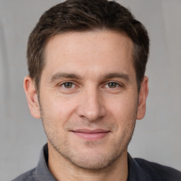 Joyful white young-adult male with short  brown hair and brown eyes