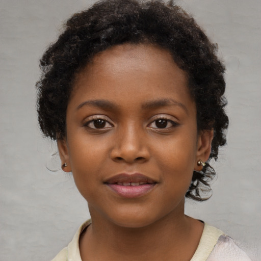 Joyful black child female with short  brown hair and brown eyes