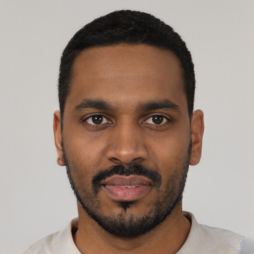 Neutral black young-adult male with short  black hair and brown eyes