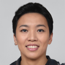 Joyful asian young-adult female with short  black hair and brown eyes