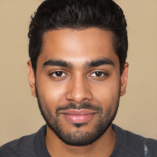 Joyful latino young-adult male with short  black hair and brown eyes