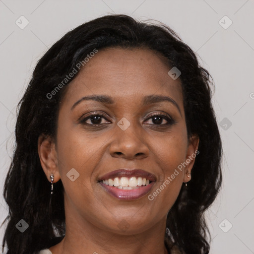 Joyful black young-adult female with long  brown hair and brown eyes