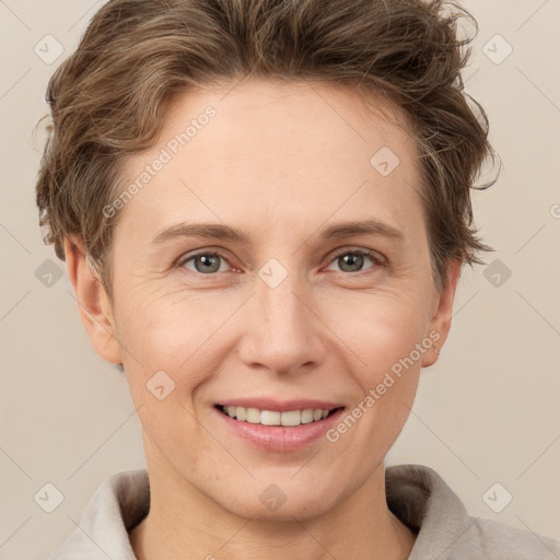 Joyful white adult female with short  brown hair and grey eyes