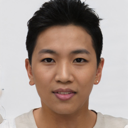 Joyful asian young-adult male with short  brown hair and brown eyes