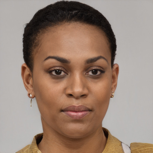 Joyful black young-adult female with short  brown hair and brown eyes