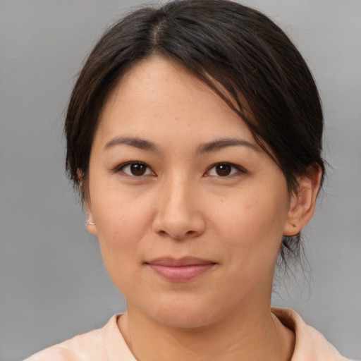 Joyful asian young-adult female with medium  brown hair and brown eyes