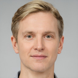 Joyful white adult male with short  brown hair and grey eyes