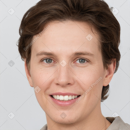 Joyful white young-adult female with short  brown hair and grey eyes