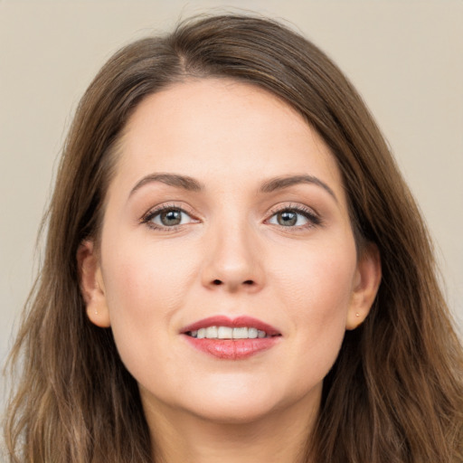 Joyful white young-adult female with long  brown hair and grey eyes