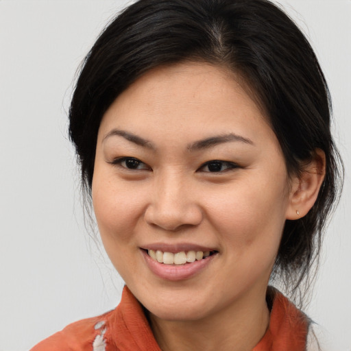 Joyful asian young-adult female with medium  brown hair and brown eyes