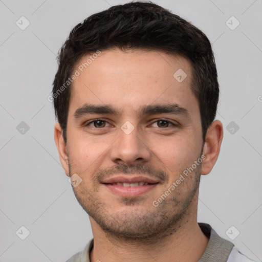 Joyful white young-adult male with short  black hair and brown eyes