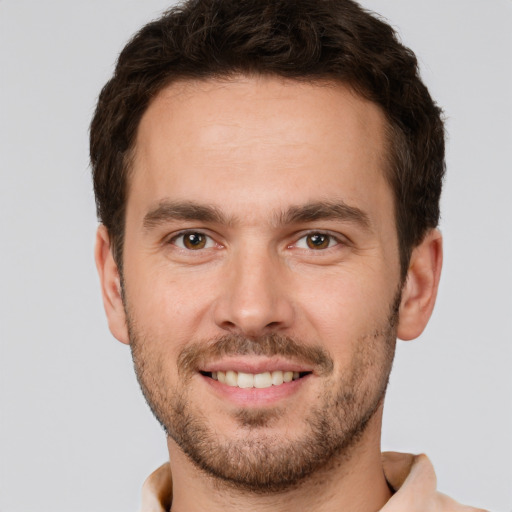 Joyful white young-adult male with short  brown hair and brown eyes