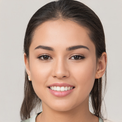 Joyful white young-adult female with long  brown hair and brown eyes