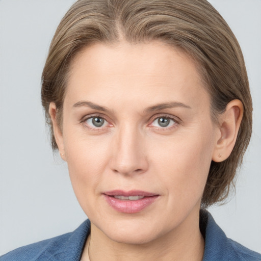 Joyful white young-adult female with medium  brown hair and blue eyes