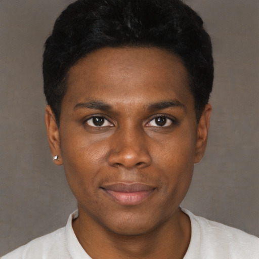 Joyful black young-adult male with short  black hair and brown eyes