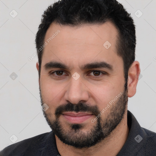 Joyful white young-adult male with short  black hair and brown eyes