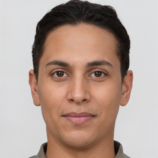 Joyful white young-adult male with short  brown hair and brown eyes