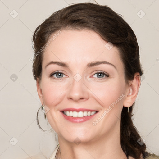 Joyful white young-adult female with medium  brown hair and grey eyes