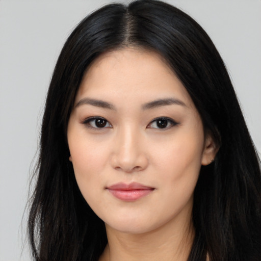 Joyful asian young-adult female with long  black hair and brown eyes