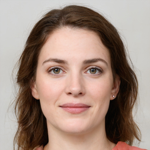 Joyful white young-adult female with medium  brown hair and green eyes