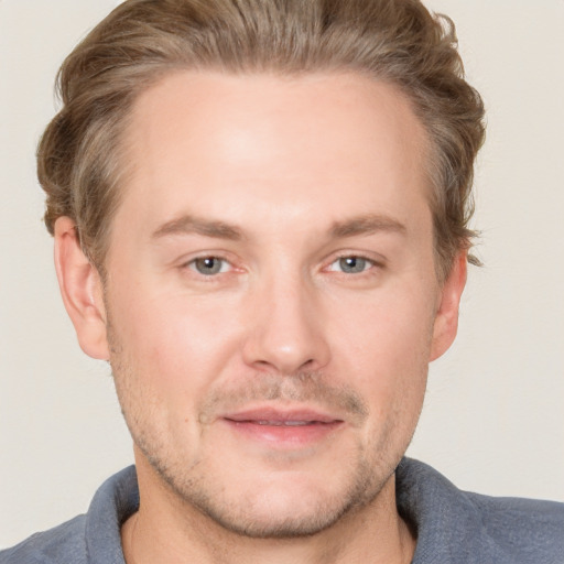 Joyful white adult male with short  brown hair and grey eyes