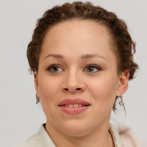 Joyful white young-adult female with short  brown hair and green eyes