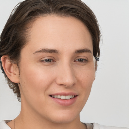 Joyful white young-adult female with short  brown hair and brown eyes