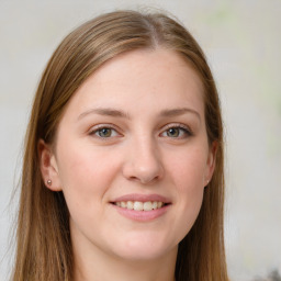 Joyful white young-adult female with long  brown hair and grey eyes