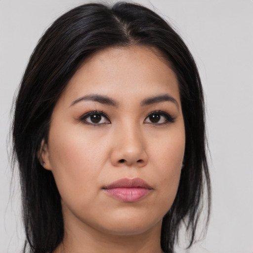 Joyful asian young-adult female with long  black hair and brown eyes