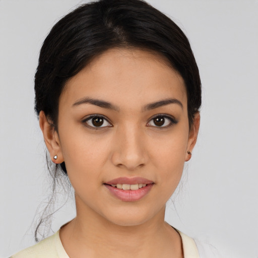 Joyful latino young-adult female with medium  black hair and brown eyes