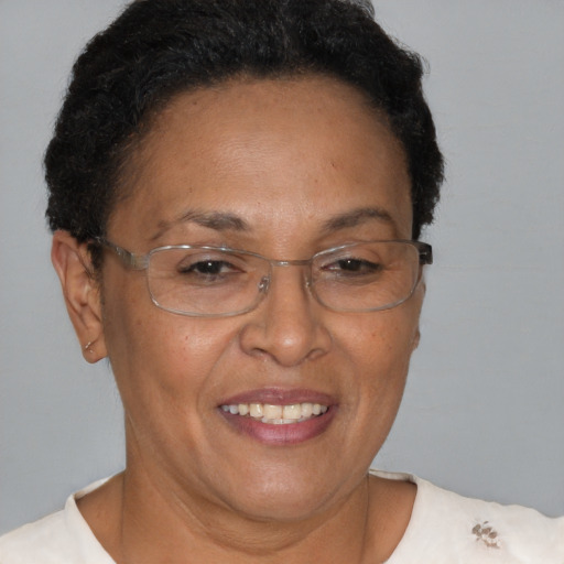 Joyful black adult female with short  brown hair and brown eyes