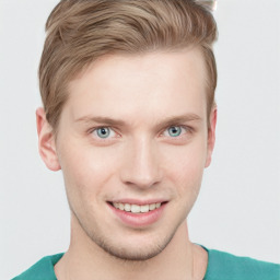 Joyful white young-adult male with short  brown hair and blue eyes