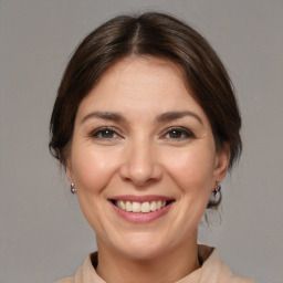 Joyful white adult female with medium  brown hair and brown eyes