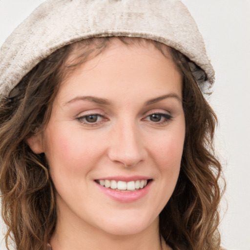 Joyful white young-adult female with long  brown hair and blue eyes