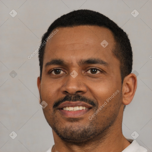 Joyful black young-adult male with short  black hair and brown eyes