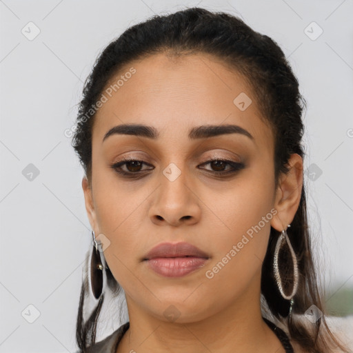 Joyful latino young-adult female with long  brown hair and brown eyes