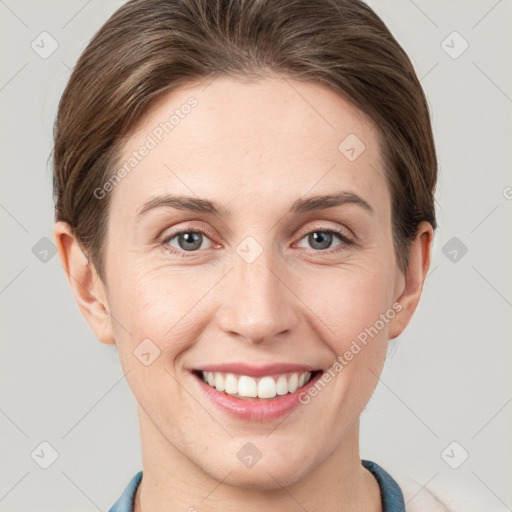 Joyful white young-adult female with short  brown hair and grey eyes