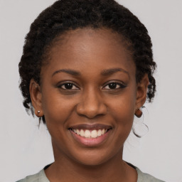 Joyful black young-adult female with short  brown hair and brown eyes