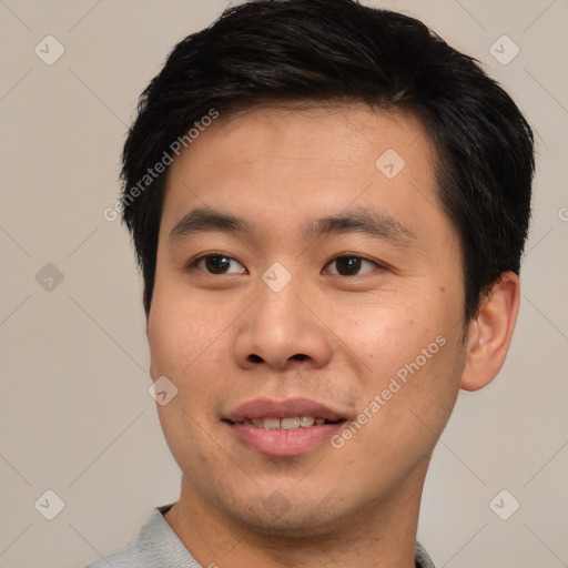 Joyful asian young-adult male with short  black hair and brown eyes