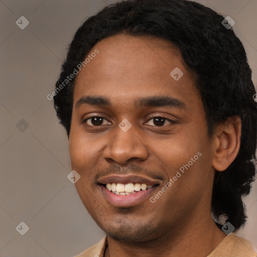 Joyful black young-adult male with short  black hair and brown eyes