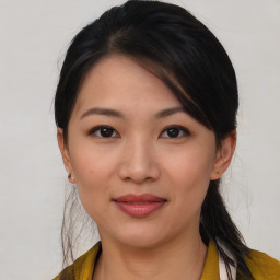 Joyful asian young-adult female with medium  black hair and brown eyes