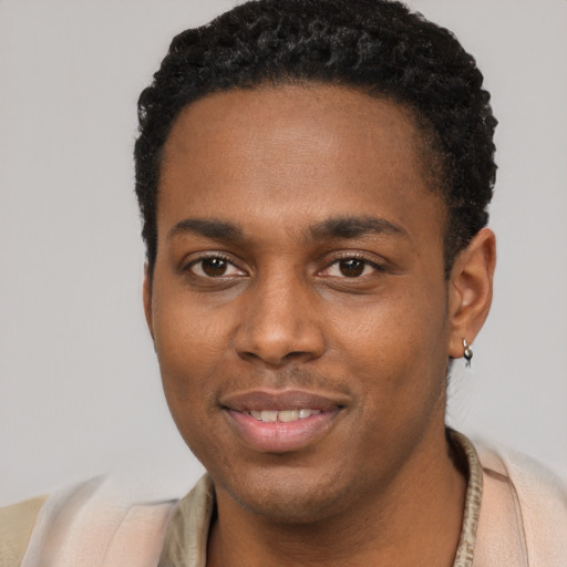 Joyful black young-adult male with short  black hair and brown eyes