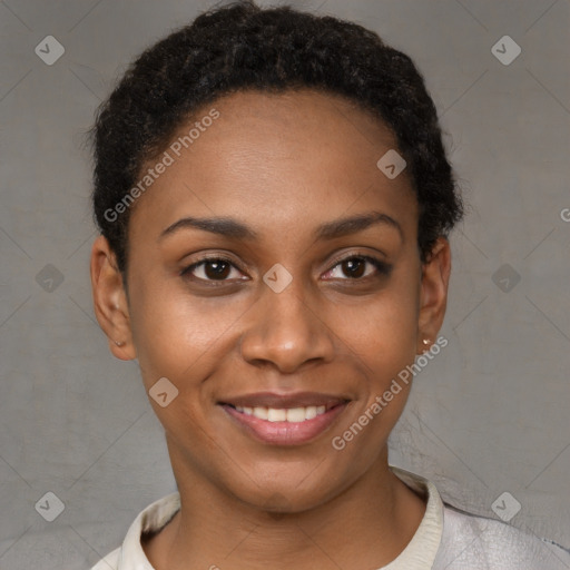 Joyful black young-adult female with short  black hair and brown eyes