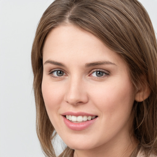 Joyful white young-adult female with long  brown hair and grey eyes