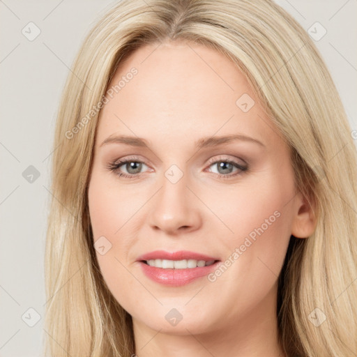 Joyful white young-adult female with long  brown hair and blue eyes