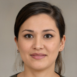 Joyful white young-adult female with medium  brown hair and brown eyes