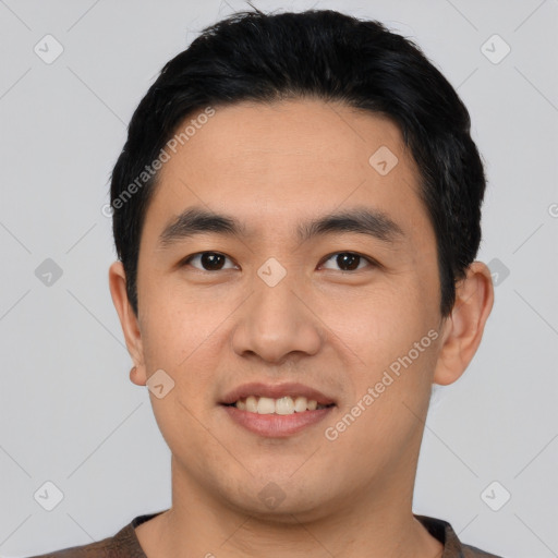 Joyful asian young-adult male with short  black hair and brown eyes